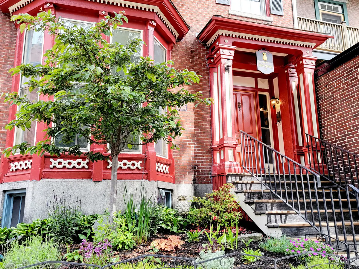 The red-trimmed brick entrance and front garden of The Parkspring Inn
